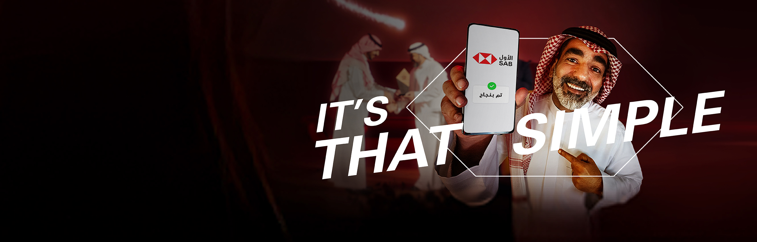 a saudi guy showing his phone with the word Baseetah written in Arabic